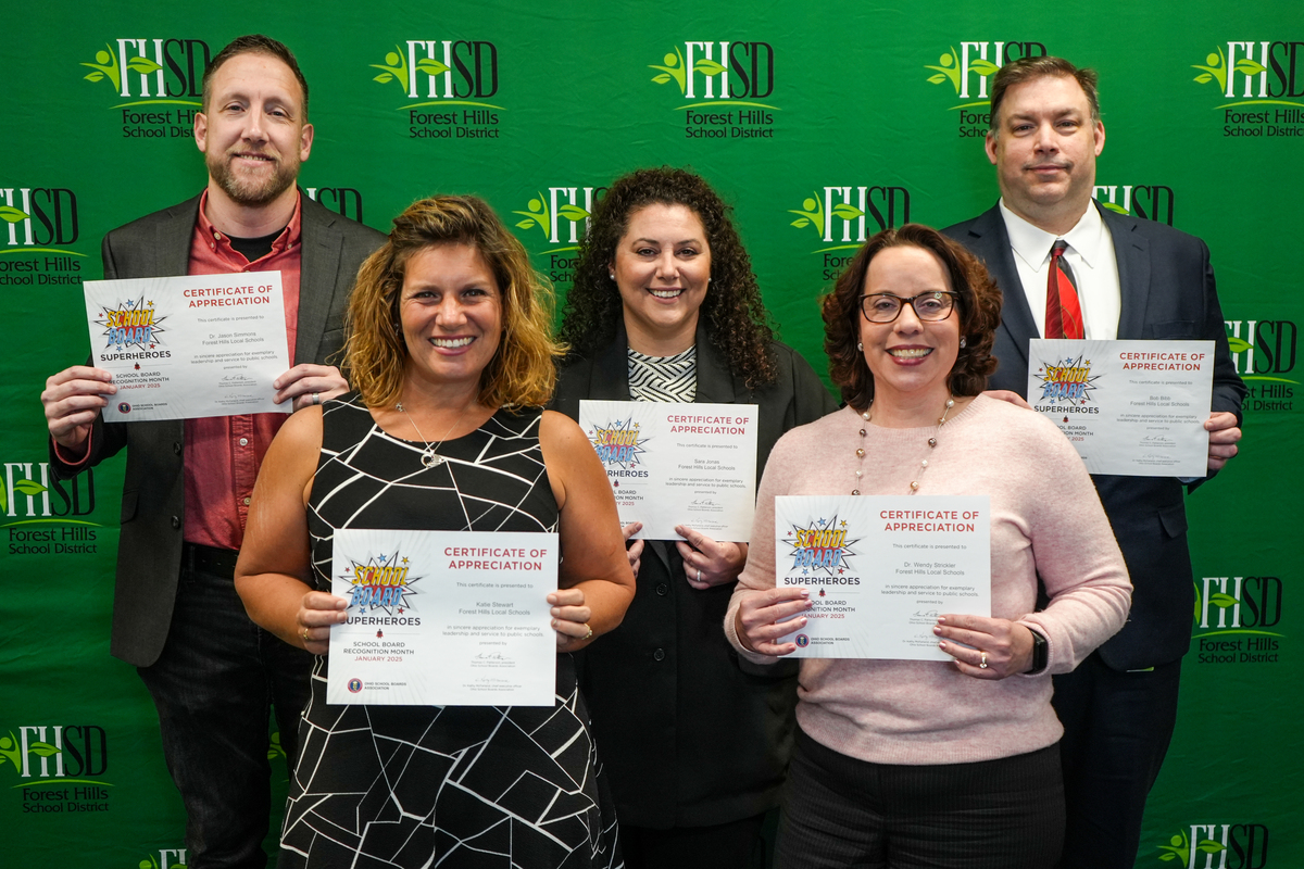 board members pose for a photo with certificates of recognition