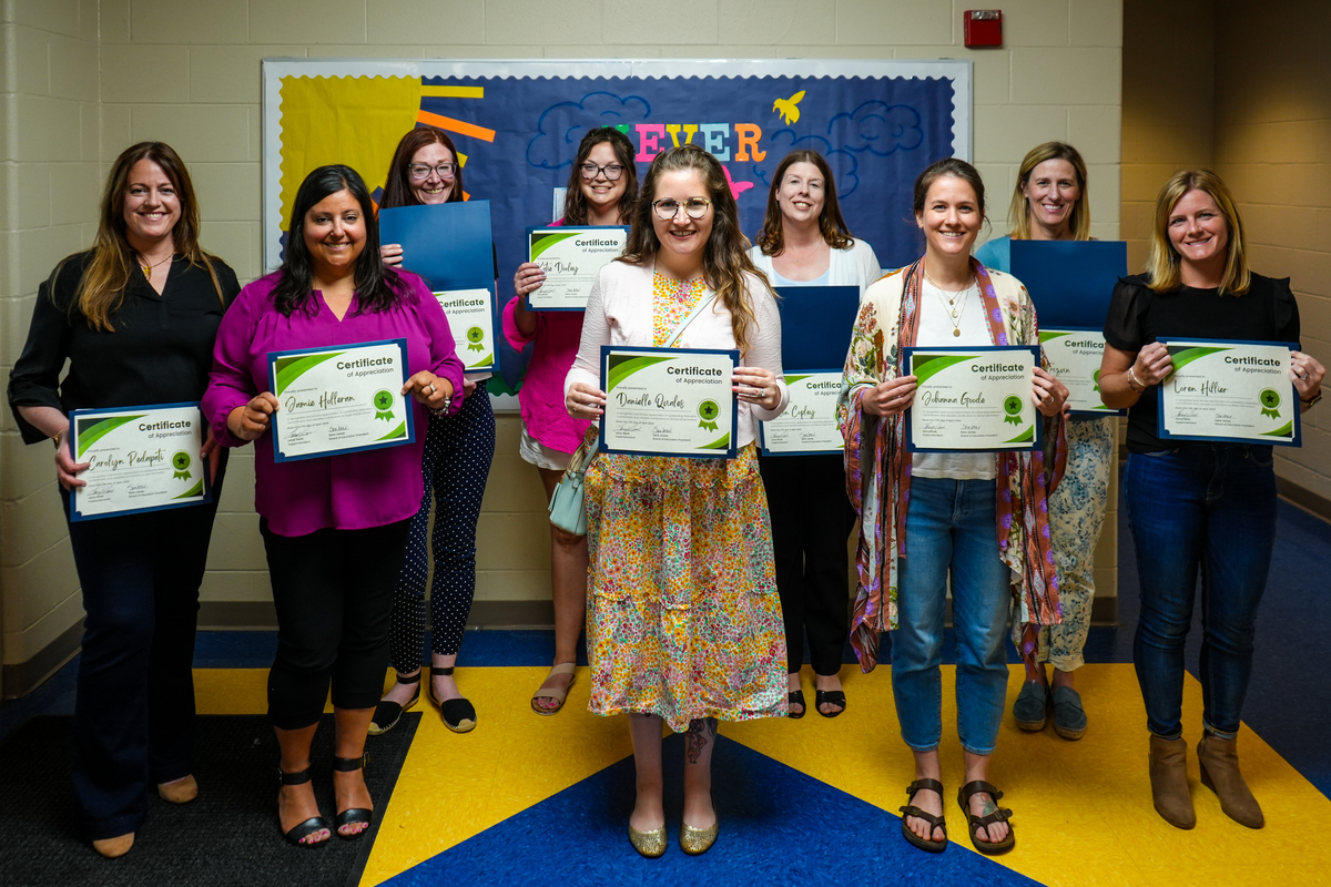 The volunteers pose for a photo with their certificates of recognition