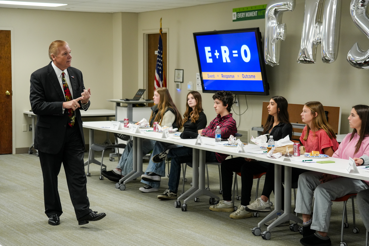 Superintendent Larry Hook speaks to a group of high school and middle school students